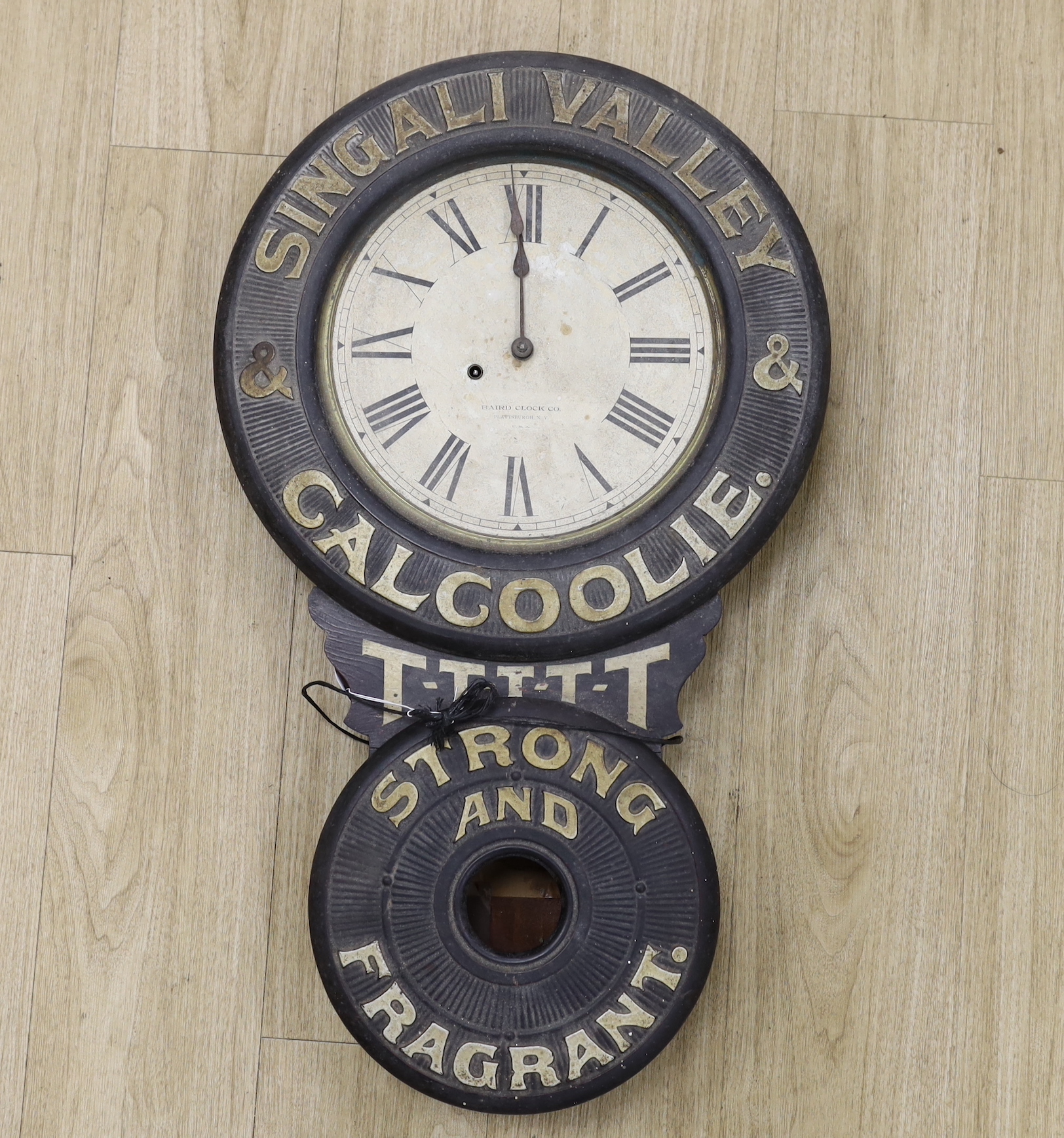 An early 20th century American Baird Clock Co. advertising wall clock “Singali Valley & Calcoolie Strong and Fragrant”, 80cm